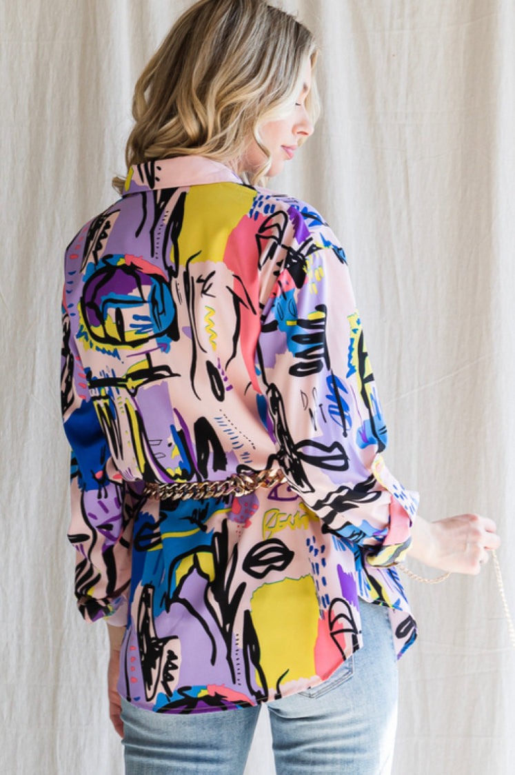 Colorful print top with a collared neck with three quarter roll-up sleeves